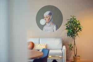 a painting of a woman in a mirror on a wall at LeonArt Living 34 in Graz