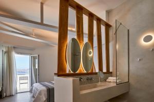 a bathroom with a sink and a mirror at Santorini View in Akrotiri