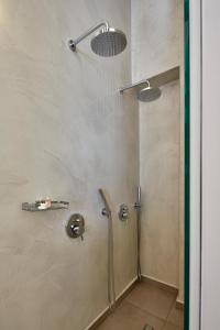 a shower stall with two lights on the wall at Santorini View in Akrotiri