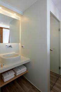 a bathroom with a sink and a mirror at Santorini View in Akrotiri