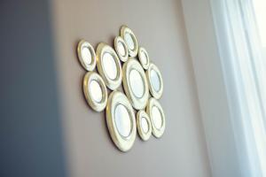 a bunch of gold plates on a wall at LeonArt Living 34 in Graz +25 photos