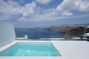 a swimming pool with a view of the water at Santorini View in Akrotiri
