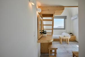 a small room with a bunk bed and a desk at Santorini View in Akrotiri