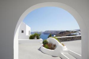 a white archway with a view of the ocean at Santorini View in Akrotiri