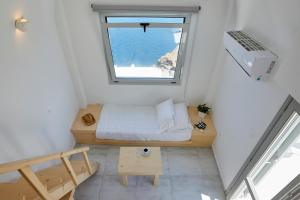 a small room with a bed and a window at Santorini View in Akrotiri