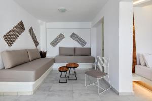 a living room with a couch and a chair at Santorini View in Akrotiri