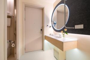 a bathroom with a sink and a mirror at Layflat Hotel in Shenzhen +37 photos