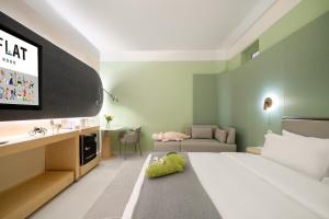 a hotel room with a bed and a tv at Layflat Hotel in Shenzhen