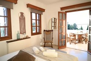 a bedroom with a bed and a dining room with a table at Villa Sea View Gem Steps to Zia Square Hot Tub in Lagoúdi Zía