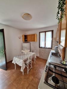 a kitchen with a table with chairs and a stove at Terrace on the green in Monterosso al Mare +49 photos