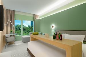 a hotel room with a bed and a desk with bottles at Layflat Hotel in Shenzhen