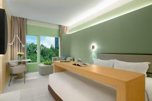 a hotel room with a bed and a desk at Layflat Hotel in Shenzhen
