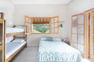 Katil atau katil-katil dalam bilik di Chacara com piscina, churrasq e WiFi, pet friendly +25 gambar