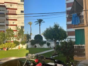widok na park z palmami i budynkami w obiekcie Apartamento Torres de Colon en Torre del Mar w mieście Torre del Mar