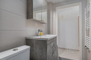 a bathroom with a sink and a toilet at The Little Loft in Pefkochori +24 photos
