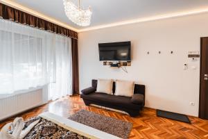 TV a/nebo společenská místnost v ubytování Melior Szálló