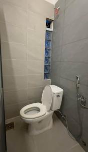 a bathroom with a white toilet in a stall at ChuChu House - Phuoc Hai Fishing Village in Ấp Lò Gốm