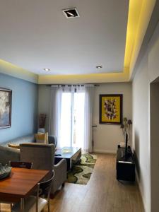 a living room with a couch and a table at Pearl of Love Apartment in Accra +2 photos