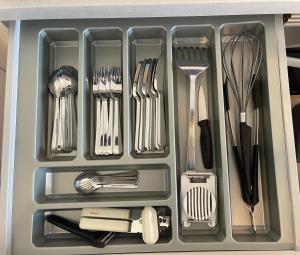 a drawer filled with utensils and other kitchen utensils at Apartment Palm Tree View in Maspalomas +21 photos