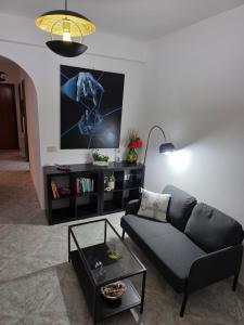 a living room with a couch and a tv at Elisabeth House in Giardini Naxos