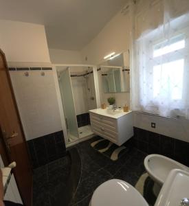 a bathroom with a sink and a shower and a toilet at Elisabeth House in Giardini Naxos +28 photos