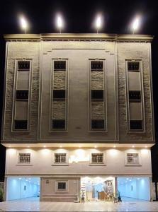 a large building with windows at night at اجنحة مأرز الايمان in Medina