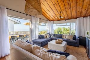 a living room with a couch and a table at Keurbooms Ocean View in Keurboomstrand