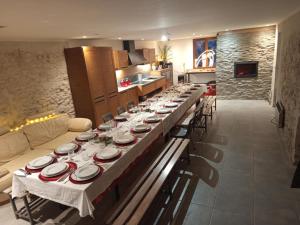 a long table with plates on it in a kitchen at Sympa Studio totalement équipé in Saint-Germain-de-Joux +12 photos