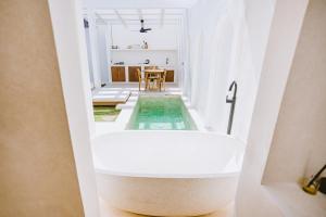a bathtub in the hallway of a house at Villa Gaia in Gili Trawangan +16 photos