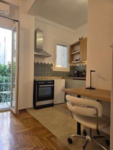 a kitchen with a wooden table and a stove at Down town in Athens