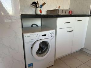 a kitchen with a washing machine and a sink at Appartement Studio à Saint Pierre la Mer près de la plage - FR-1-229D-149 in Fleury