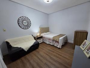 a bedroom with two beds and a mirror on the wall at Loft Arara Manaus in Manaus