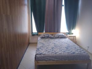 a small bed in a room with a window at Melaya Budget Hostel in Faro +16 photos
