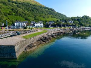 an aerial view of a river with houses and mountains at Holly Tree Hotel, Swimming Pool & Hot Tub in Glencoe +24 photos