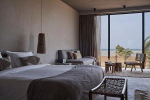 A bed or beds in a room at Casa Cook El Gouna - Adults Only