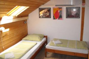 A bed or beds in a room at Hungaria Guesthouse