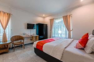 a bedroom with a bed and a desk and a television at Dancenter Gunung Geulis Villagee in Bogor