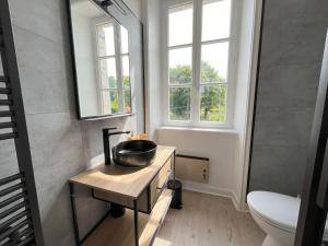 a bathroom with a sink and a toilet and window at Maison Kersaliou, proche mer St Pol de Léon in Saint-Pol-de-Léon +48 photos