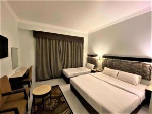 Postel nebo postele na pokoji v ubytování SH Hotel