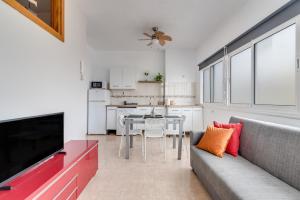 a living room with a couch and a table at Home2Book Charming Rooftop Vibes Apartment in Santa Maria de Guia de Gran Canaria