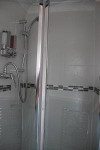 a shower with a glass door in a bathroom at The Elmfield in Great Yarmouth