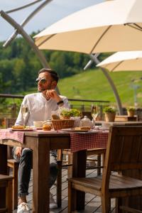 a man sitting at a table with a plate of food at Hotel SPA Dr Irena Eris Krynica Zdrój in Krynica Zdrój +52 photos