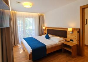 Postel nebo postele na pokoji v ubytování Engadin Lodge PREMIUM & PRIVATE