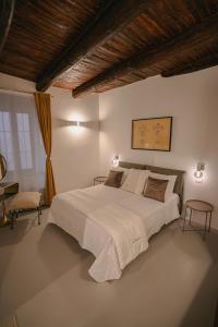 a bedroom with a large white bed in a room at Lùbea Apartment - Vinto House Collections in Salerno