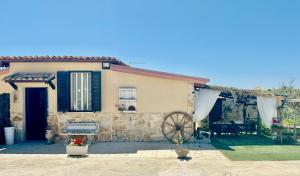 a small house with a wheel in front of it at "The Cottage"with sea view, parking & wifi in Avola