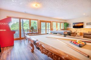 a pool table in a living room with a pool table at Change of Attitude By Avada Properties in Sevierville
