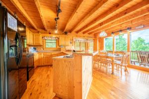 a kitchen with wooden cabinets and a table with chairs at Change of Attitude By Avada Properties in Sevierville