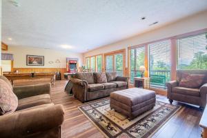 a living room with couches and a pool table at Change of Attitude By Avada Properties in Sevierville