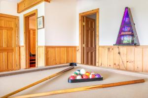 a room with a pool table with balls on it at Change of Attitude By Avada Properties in Sevierville