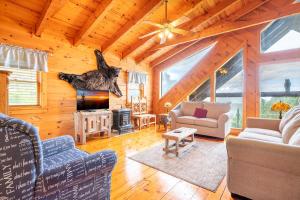 a living room with a fireplace in a log cabin at Change of Attitude By Avada Properties in Sevierville